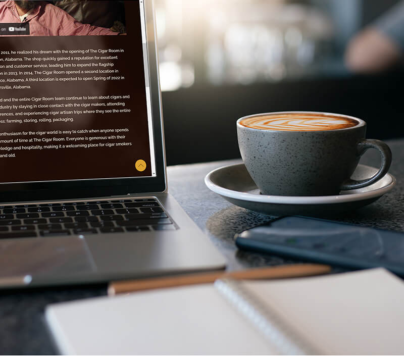 mug notebook and laptop on table