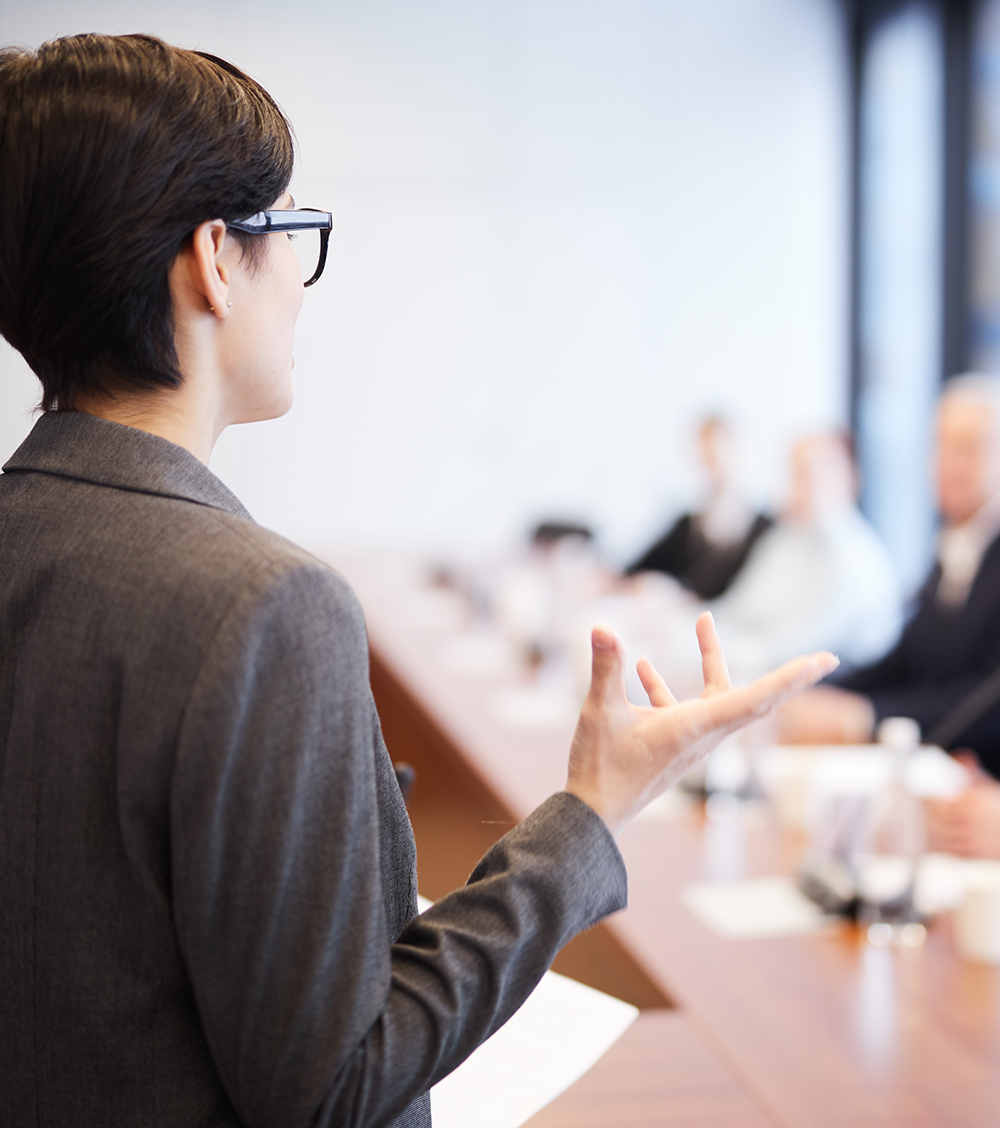 woman entering conference room as seen from behind her